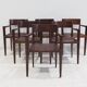 Set of six Italian wooden dining chairs in dark brown faux leather.