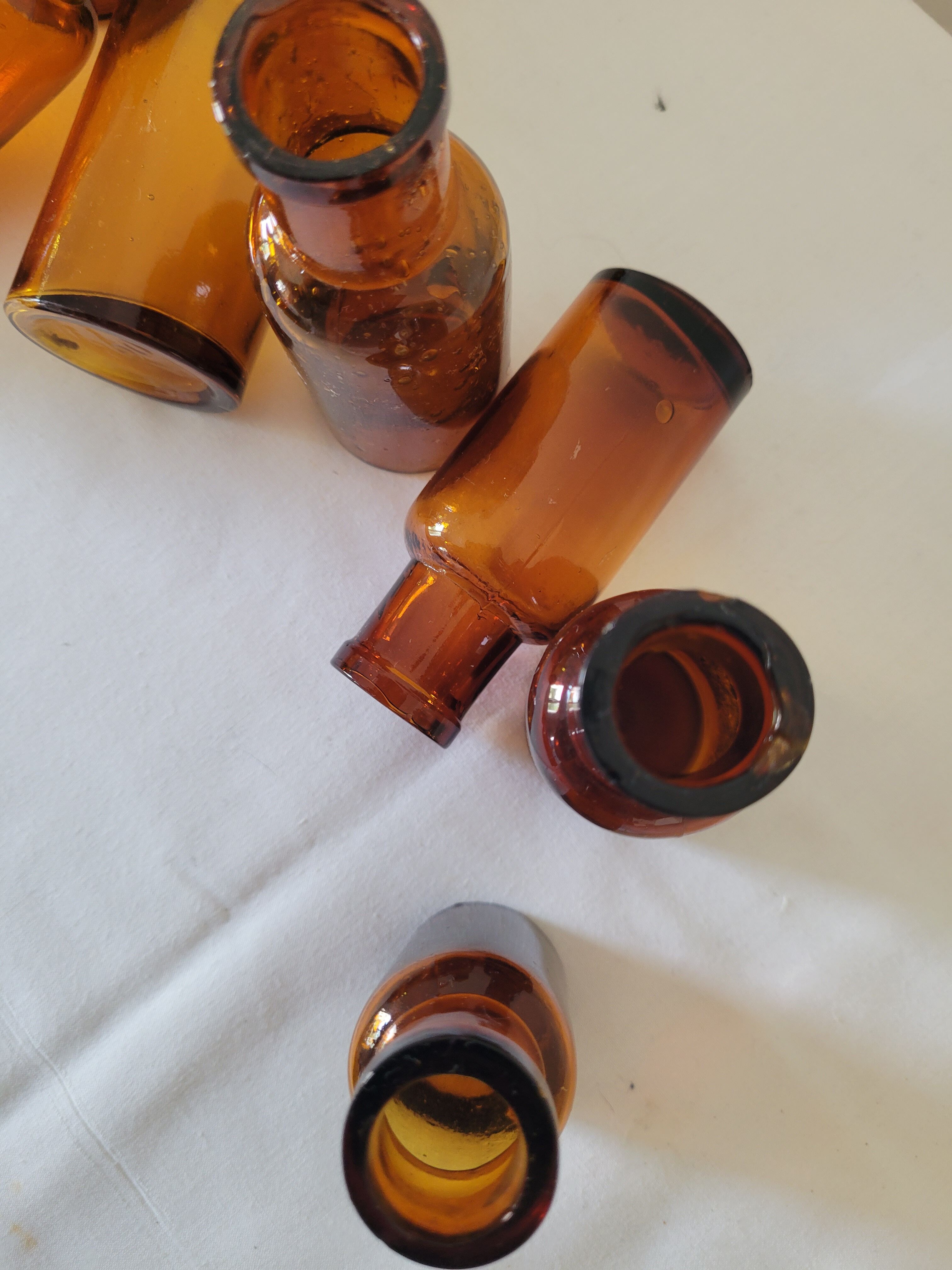 11 bottles of amber glass apothecary