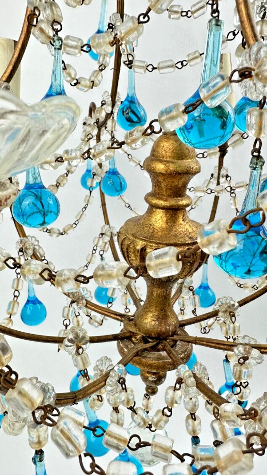 Italian chandelier with blue beads and gilded wood.