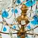 Italian chandelier with blue beads and gilded wood.