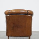 Unique vintage cognac-coloured leather club armchair with black piping