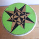 Small wooden stool painted with a star design.