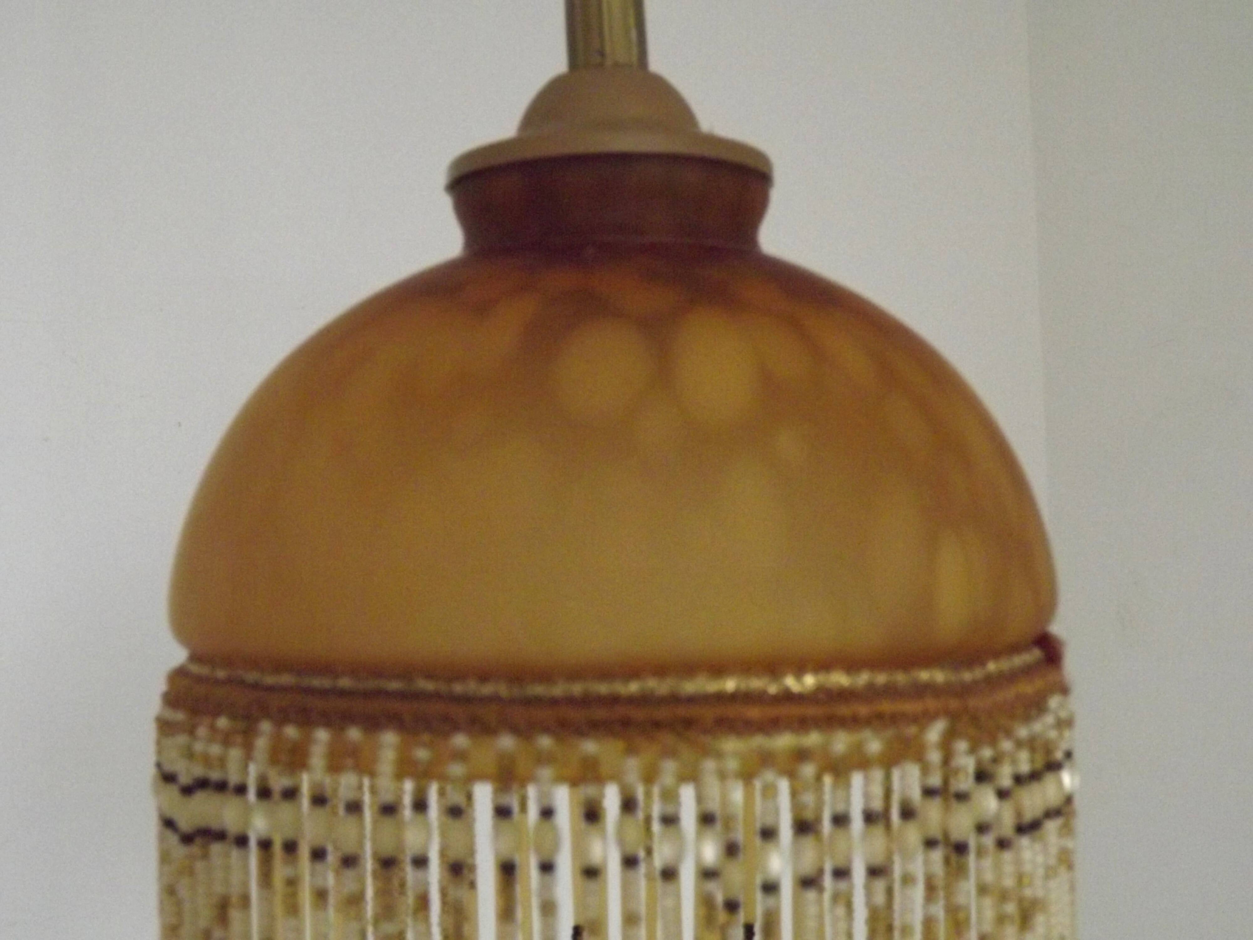 Vintage French amber mottled glass hanging ceiling light with beaded fringe.