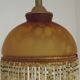 Vintage French amber mottled glass hanging ceiling light with beaded fringe.