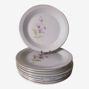 8 flat earthenware plates decorated with hollyhocks