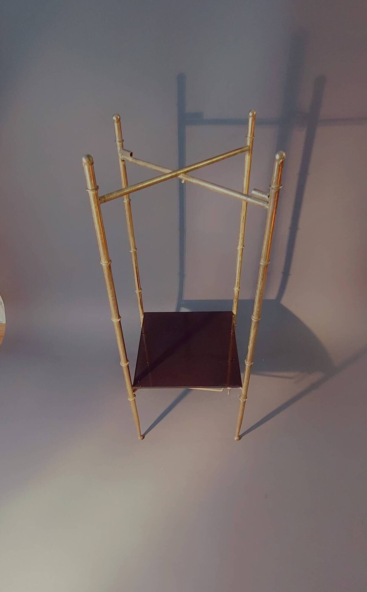 Pedestal table in patinated gilded brass faux foldable bamboo.