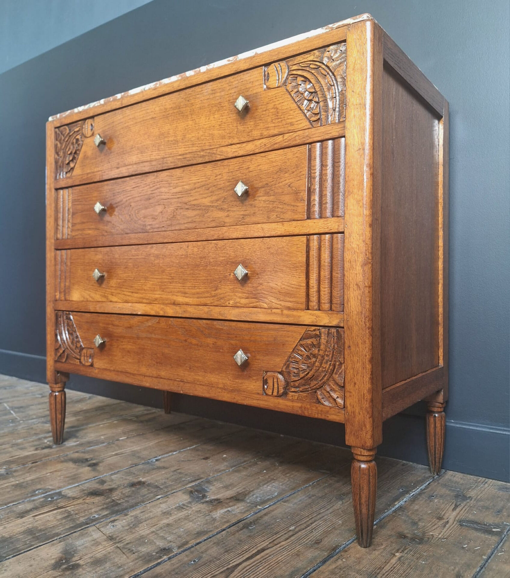 Art Deco commode with marble top, vintage antique furniture.