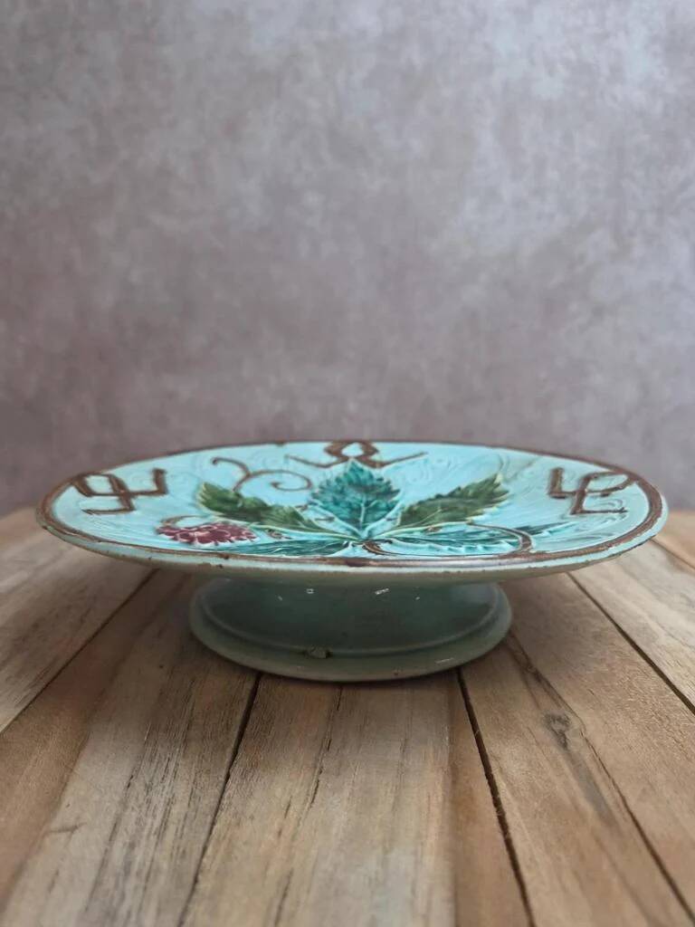 Old small compote dish in turquoise majolica with raised floral decoration.