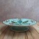 Old small compote dish in turquoise majolica with raised floral decoration.