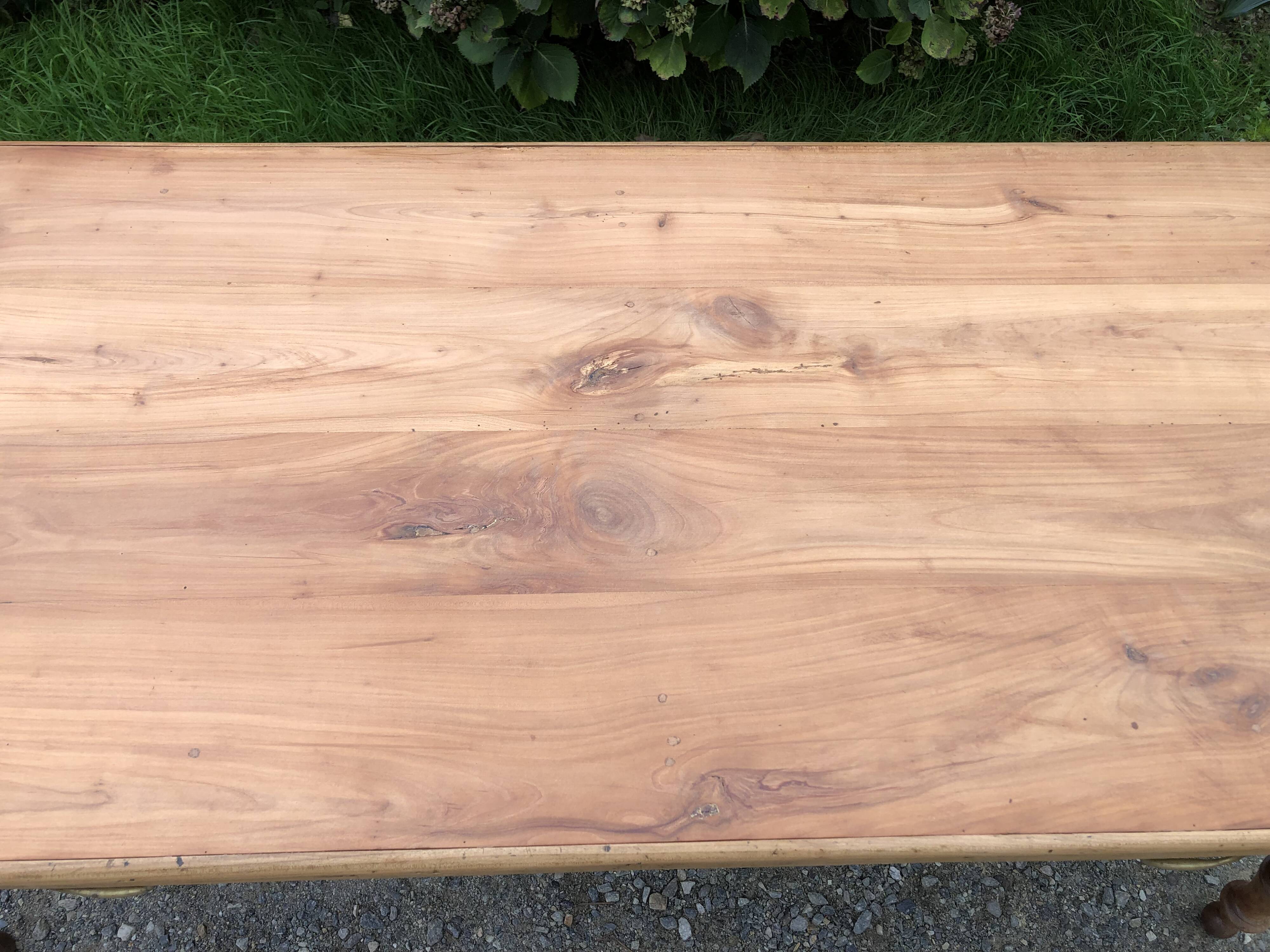 Antique Louis Philippe style farm table in solid cherry wood with 2 drawers and turned base.