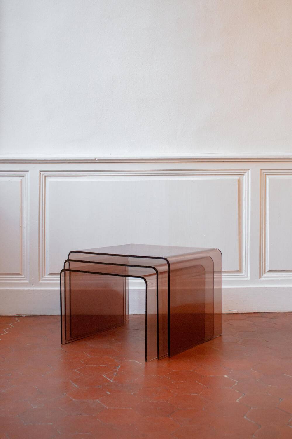 Vintage trio of nesting tables in smoked plexiglass by Michel Dumas, year.