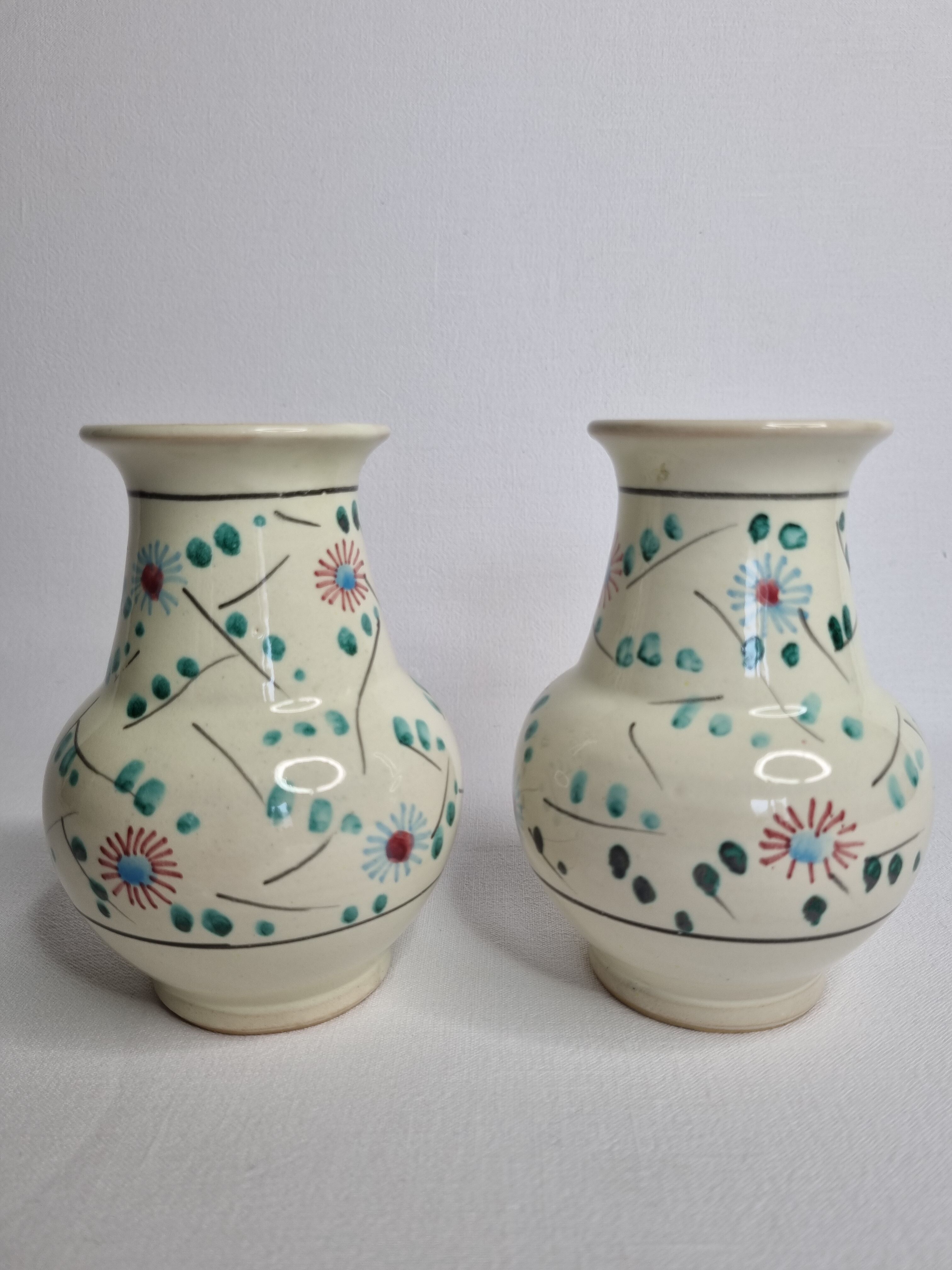 Pair of hand decorated enamelled ceramic vases, 13 cm