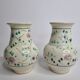 Pair of hand decorated enamelled ceramic vases, 13 cm