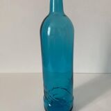 Blue glass bottle with embossed patterns at the bottom. Selters brand.