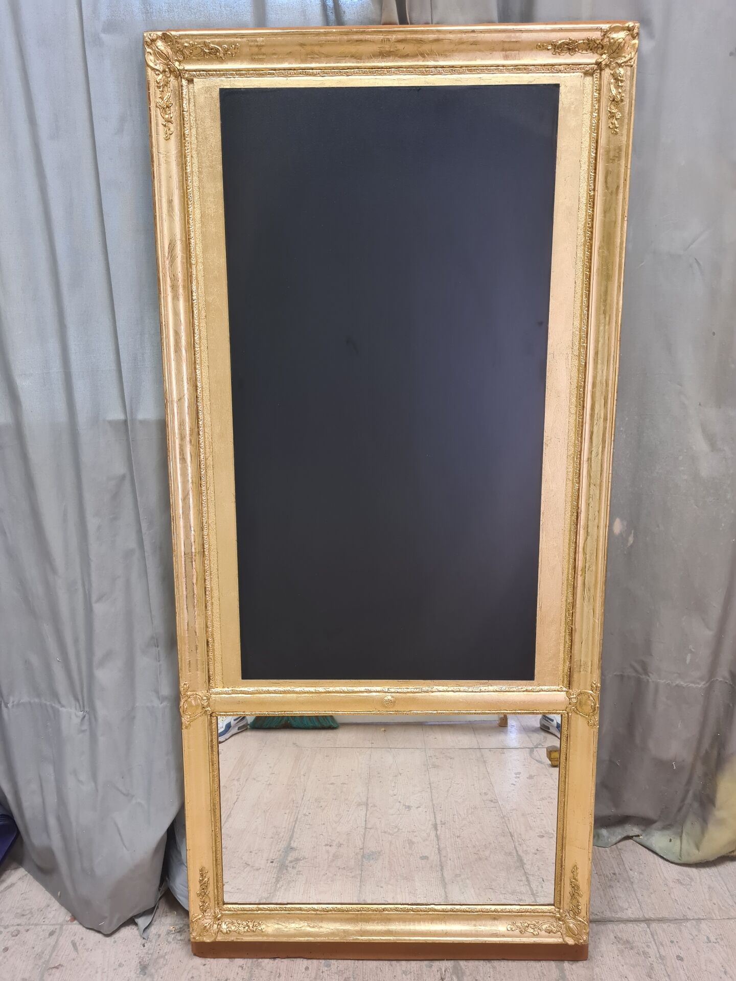 19th-century gilded trumeau mirror with restaurant slate.