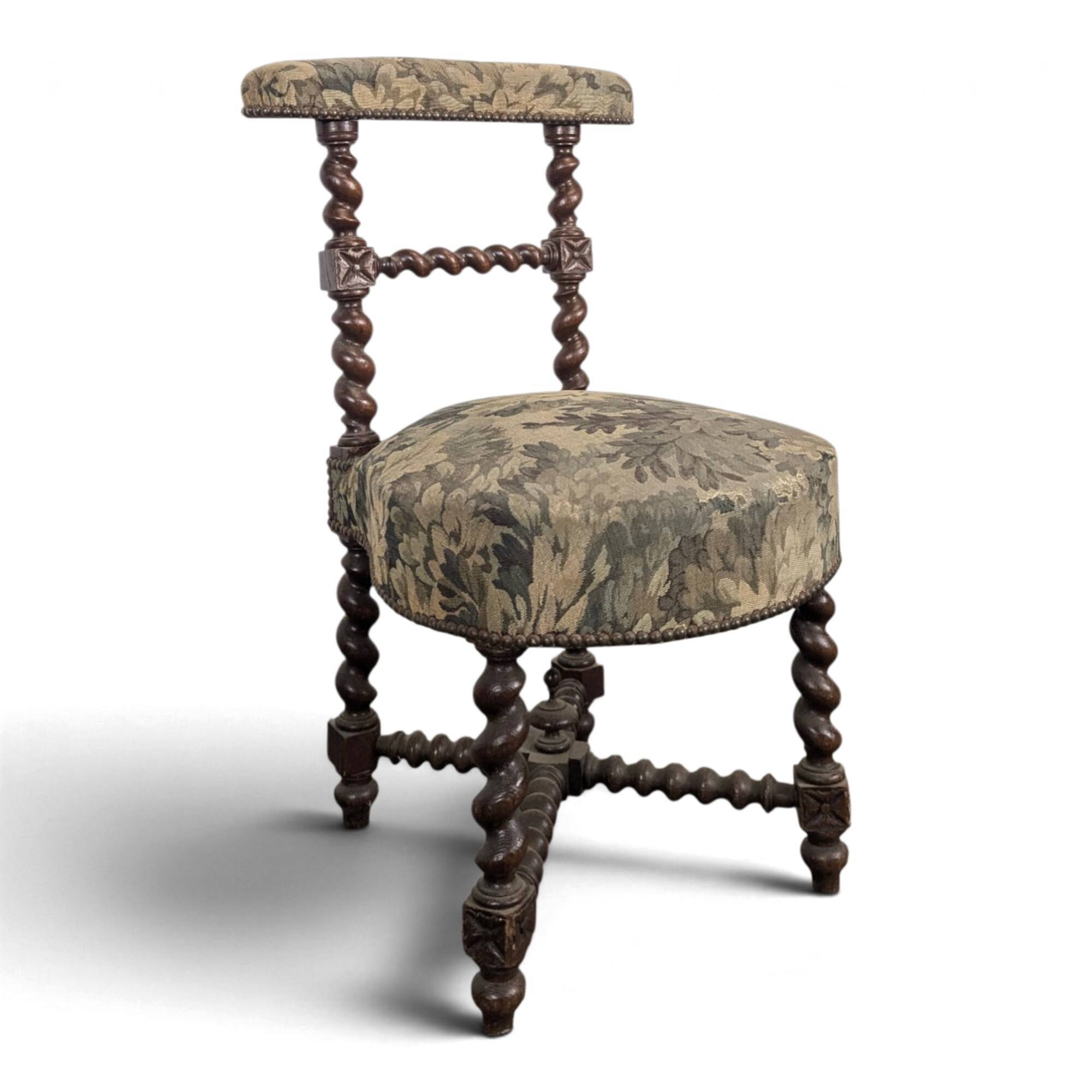 Napoleon III smoking chair in twisted blackened wood with foliage upholstery.