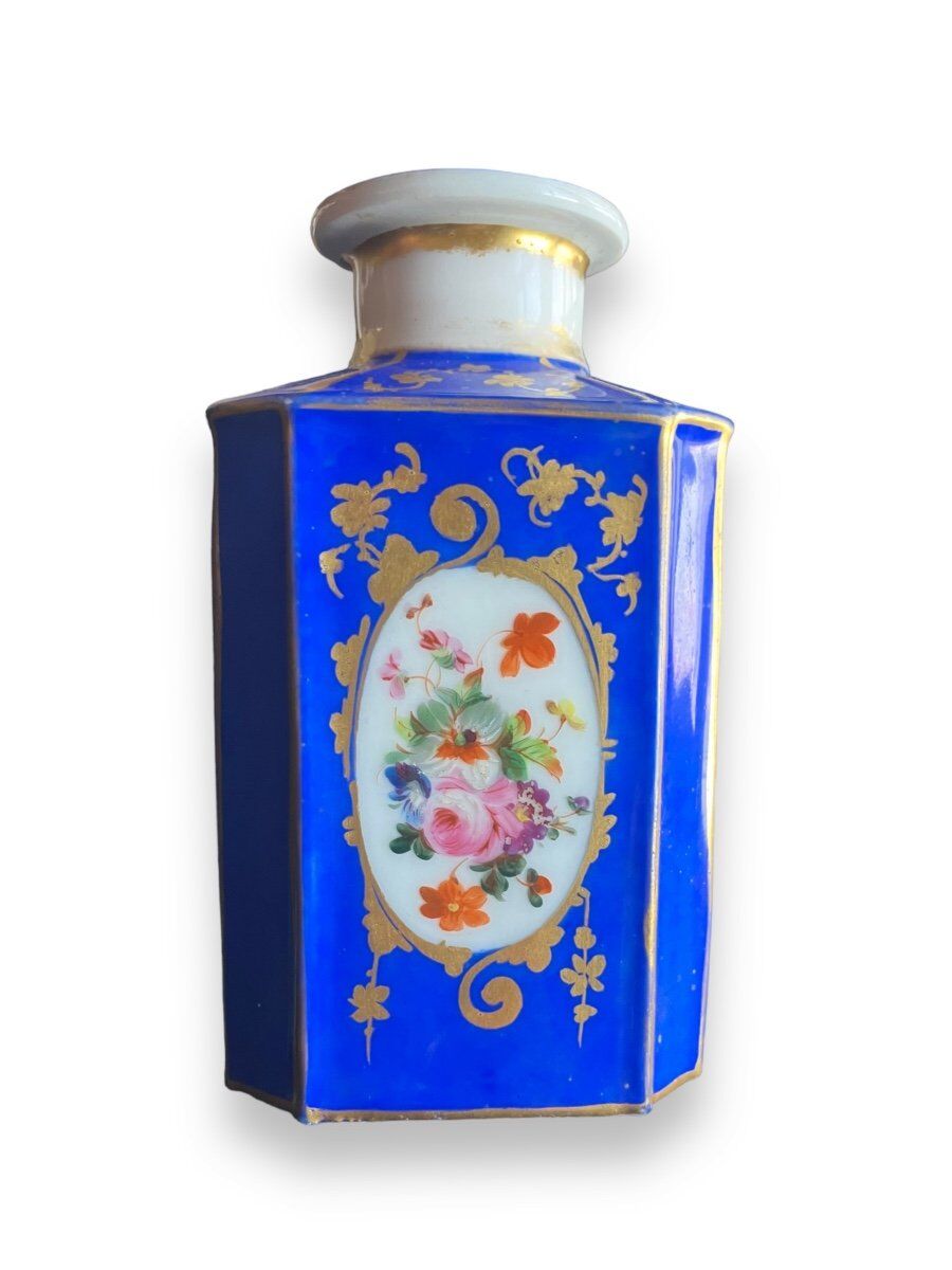 Perfume bottle in porcelain of old paris blue background