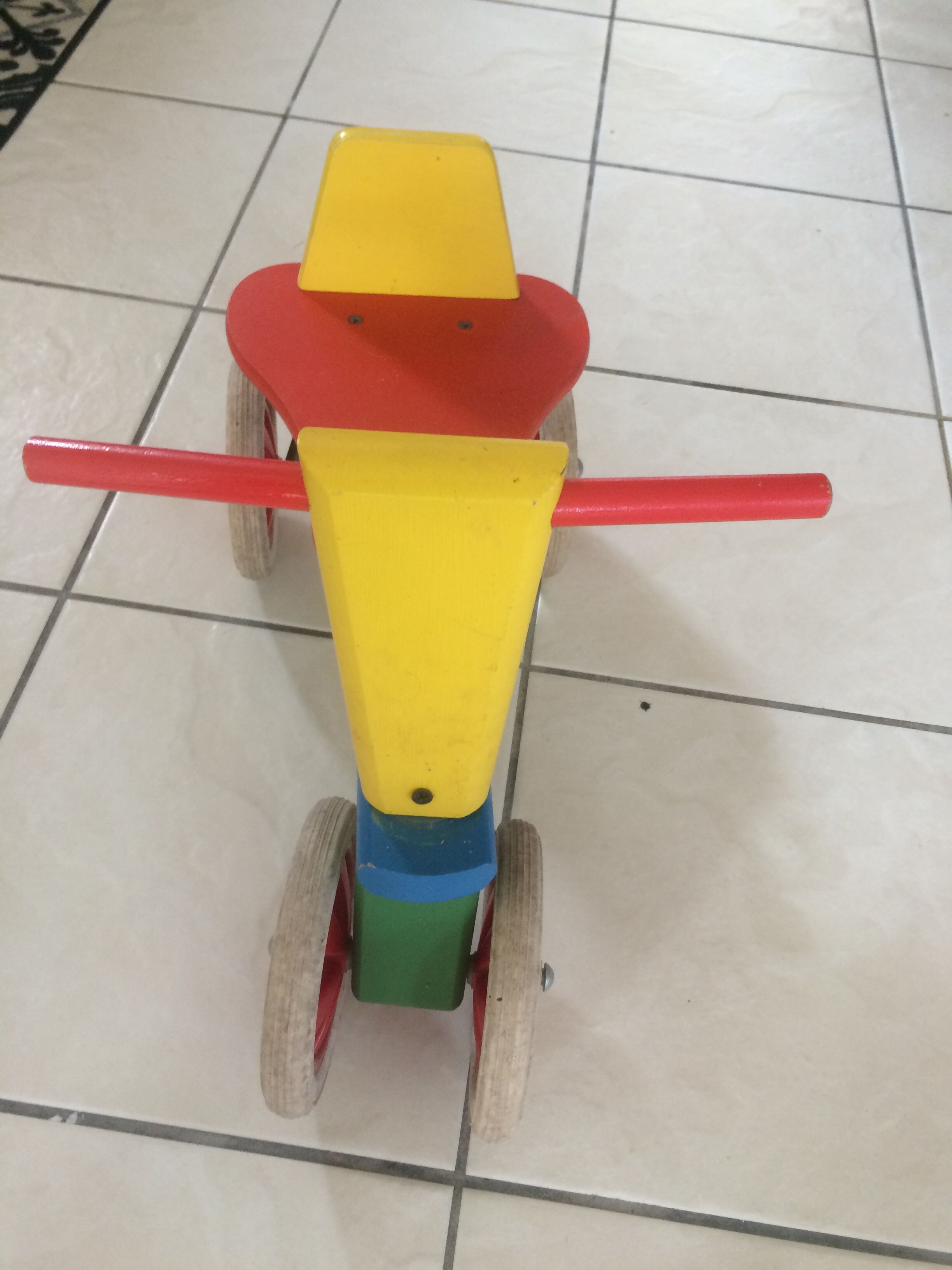 Colourful wooden 4-wheeled cycle. End of the 1970s.