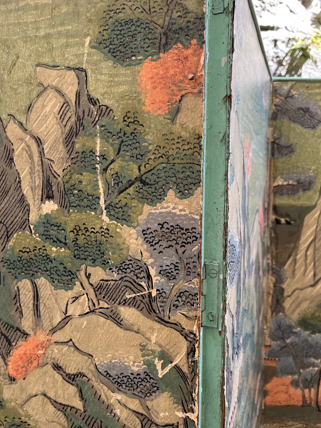 Wooden screen in Asian style, covered with Chinese wallpaper.