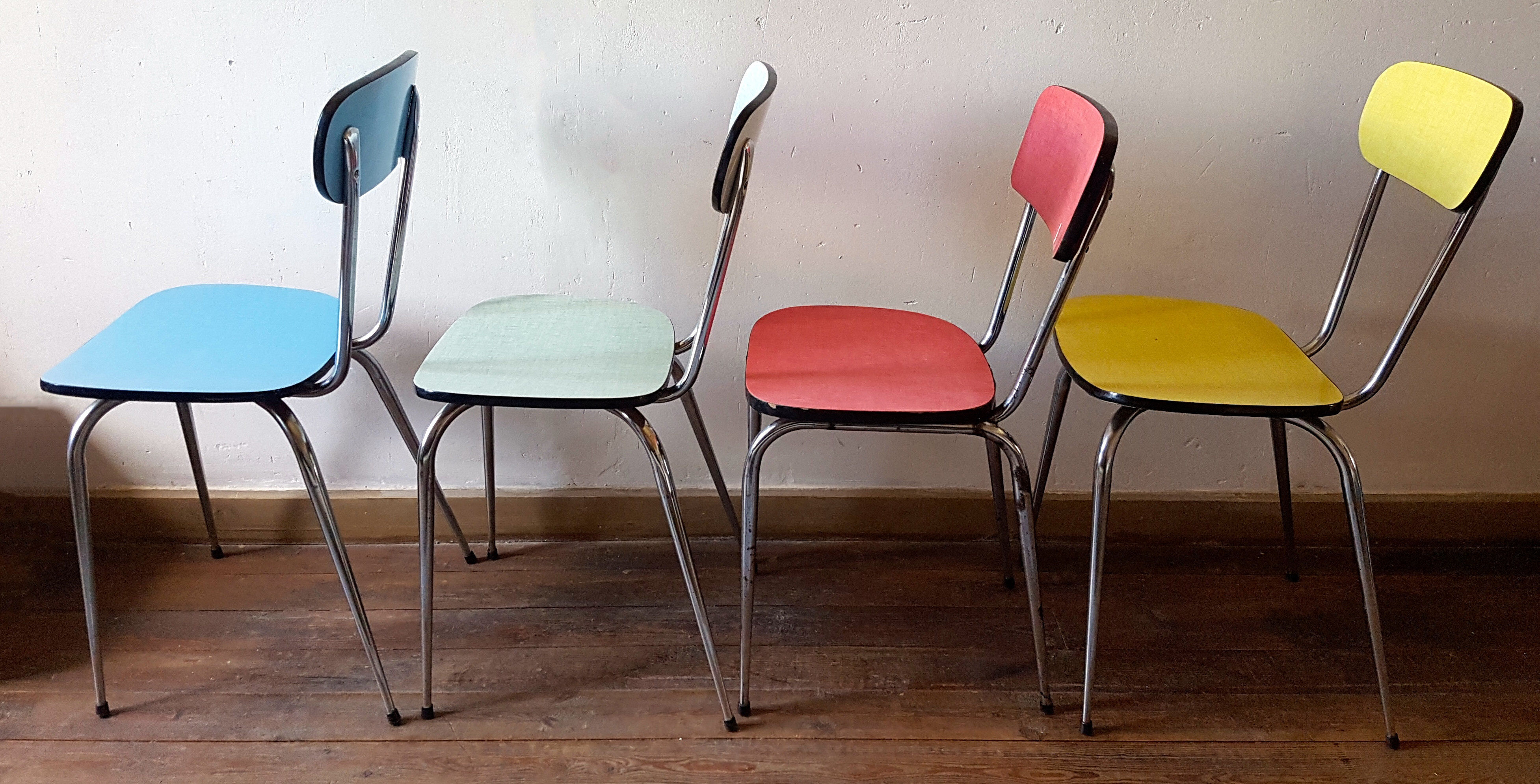 Four formica chairs in different colors