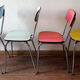 Four formica chairs in different colors