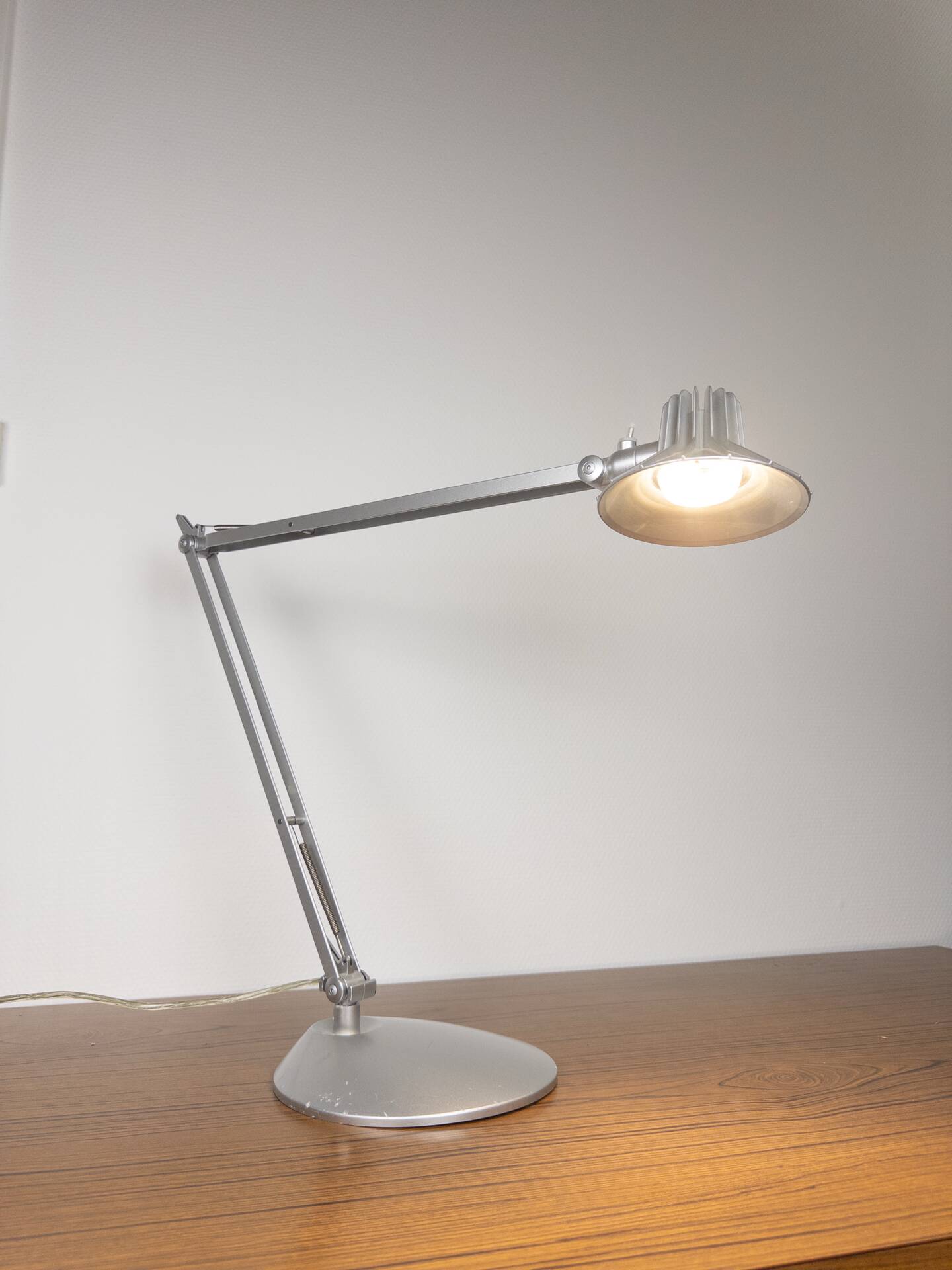 Grey LED architect lamp with spring arm and swivel base.