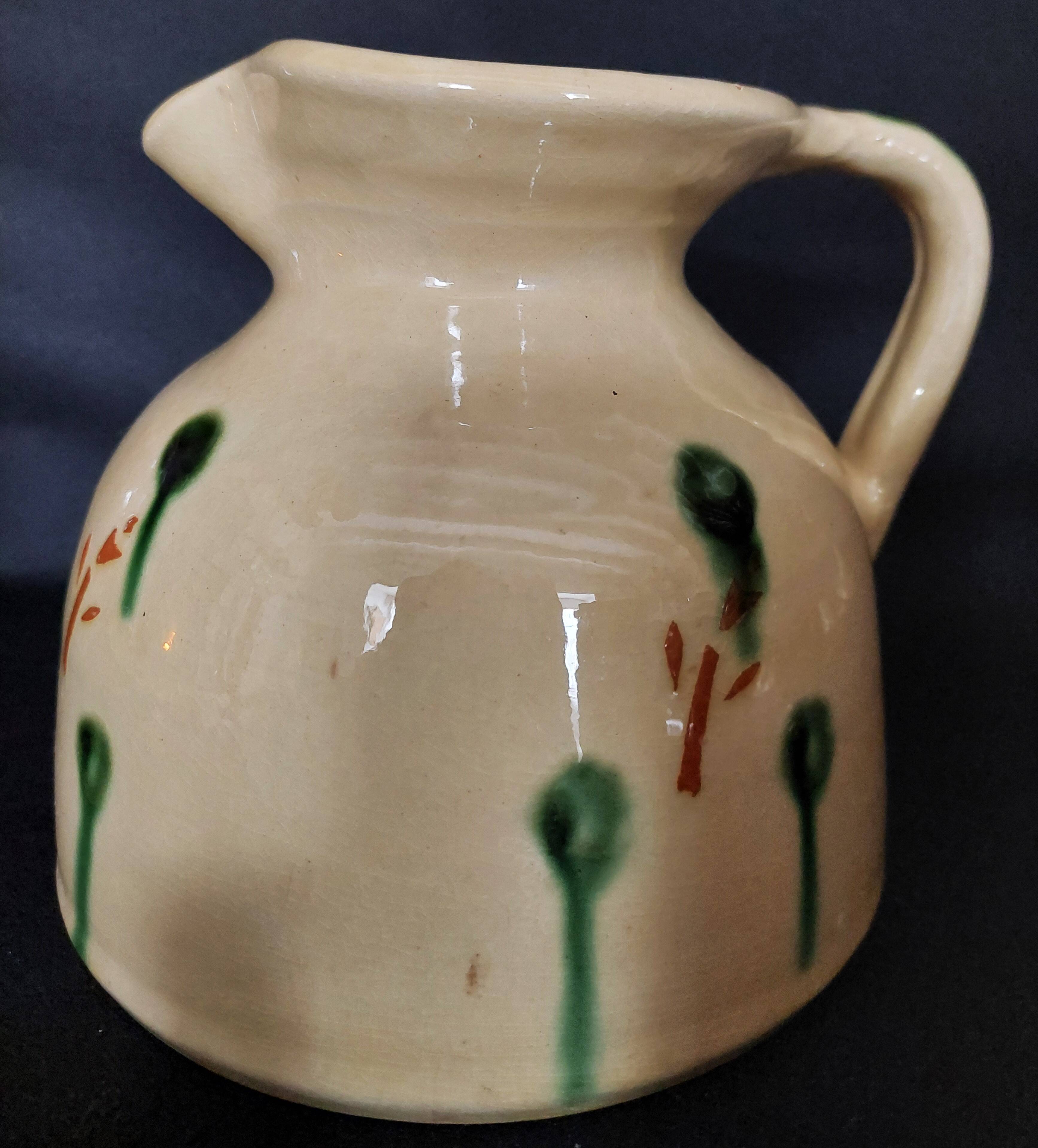 Vintage glazed terracotta ceramic jug from the 20th century.