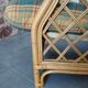 Vintage armchair in bamboo and rattan with a tartan pattern.