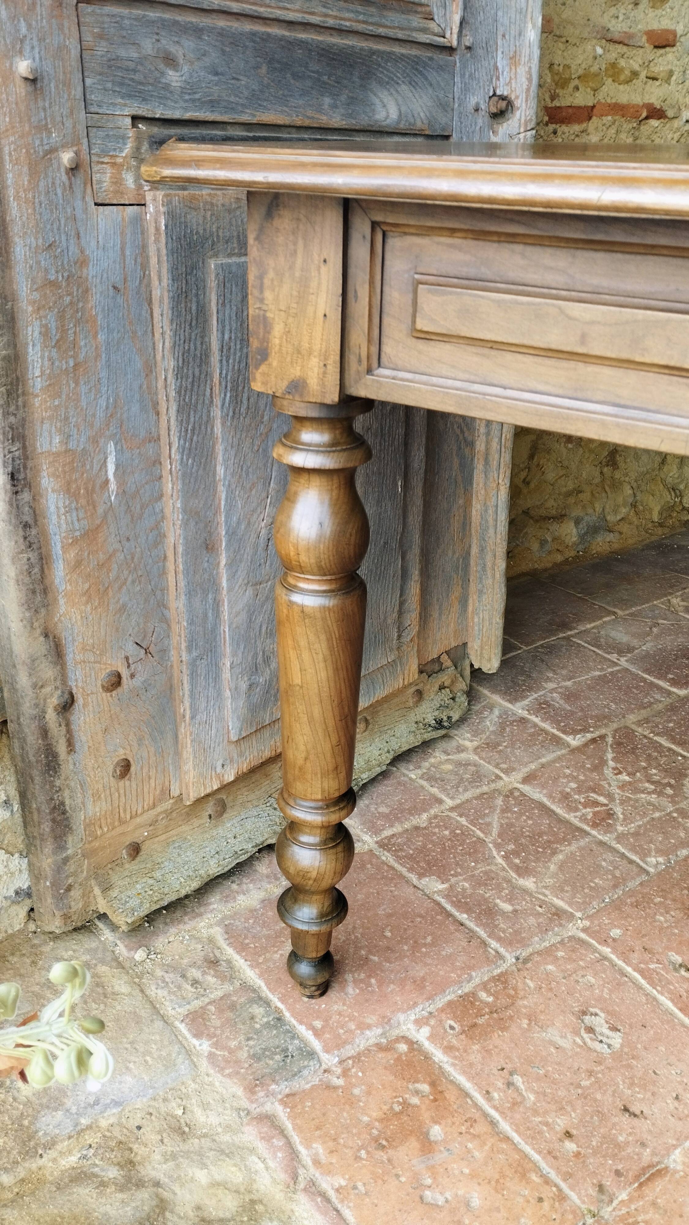 Old French farmhouse table in walnut with turned legs.