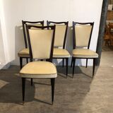 Four white leatherette chairs