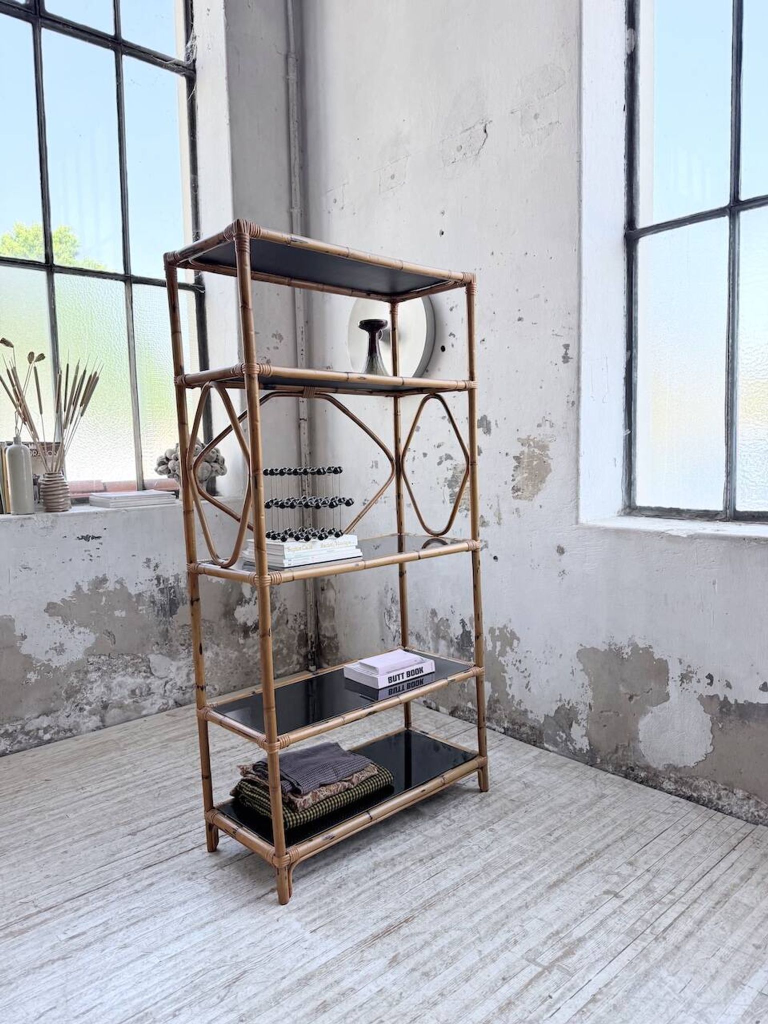 Rattan bookshelf and black glasses