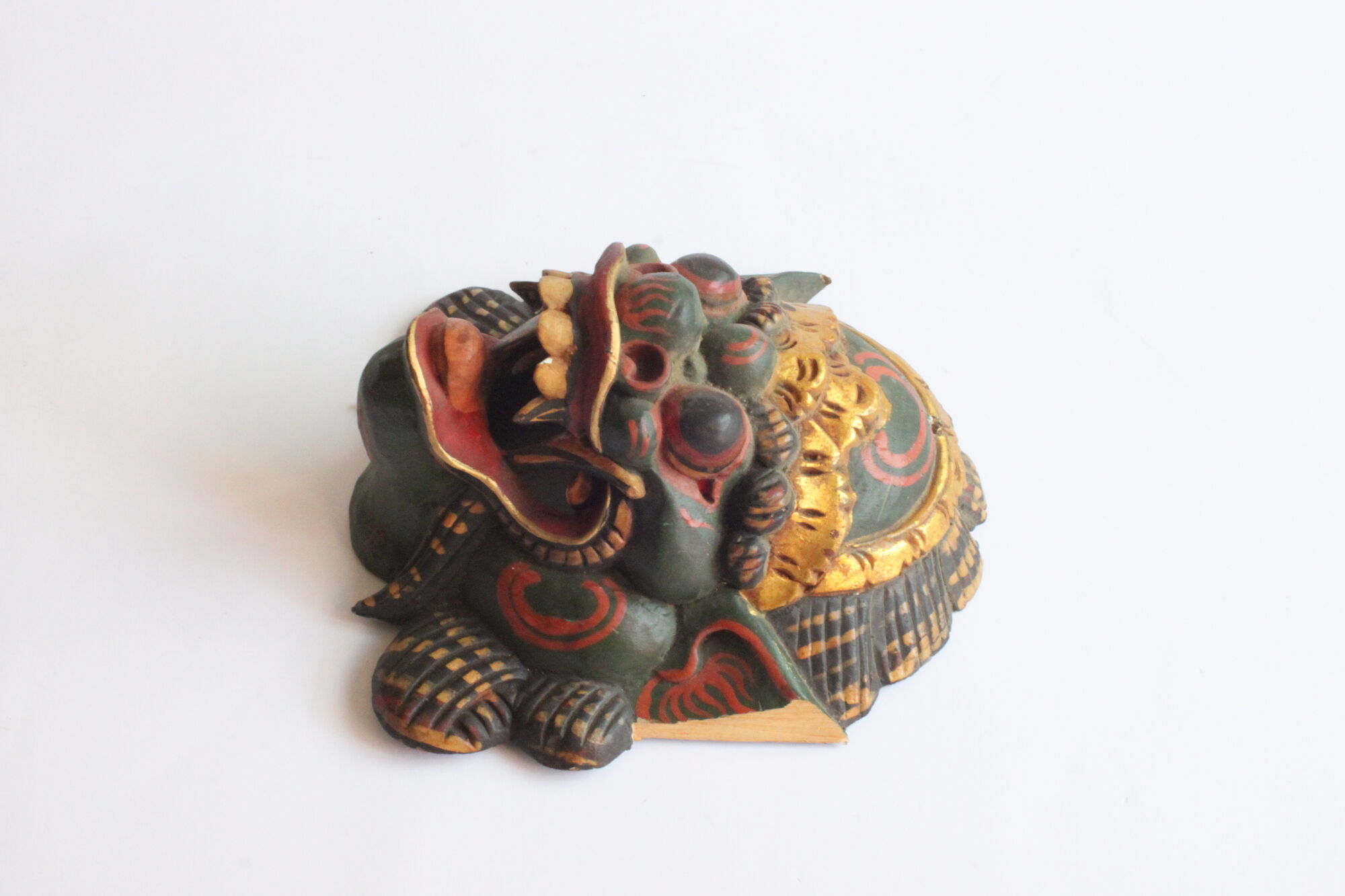 Two polychrome painted and gold leaf gilded Barong dance masks from Bali, Indonesia.