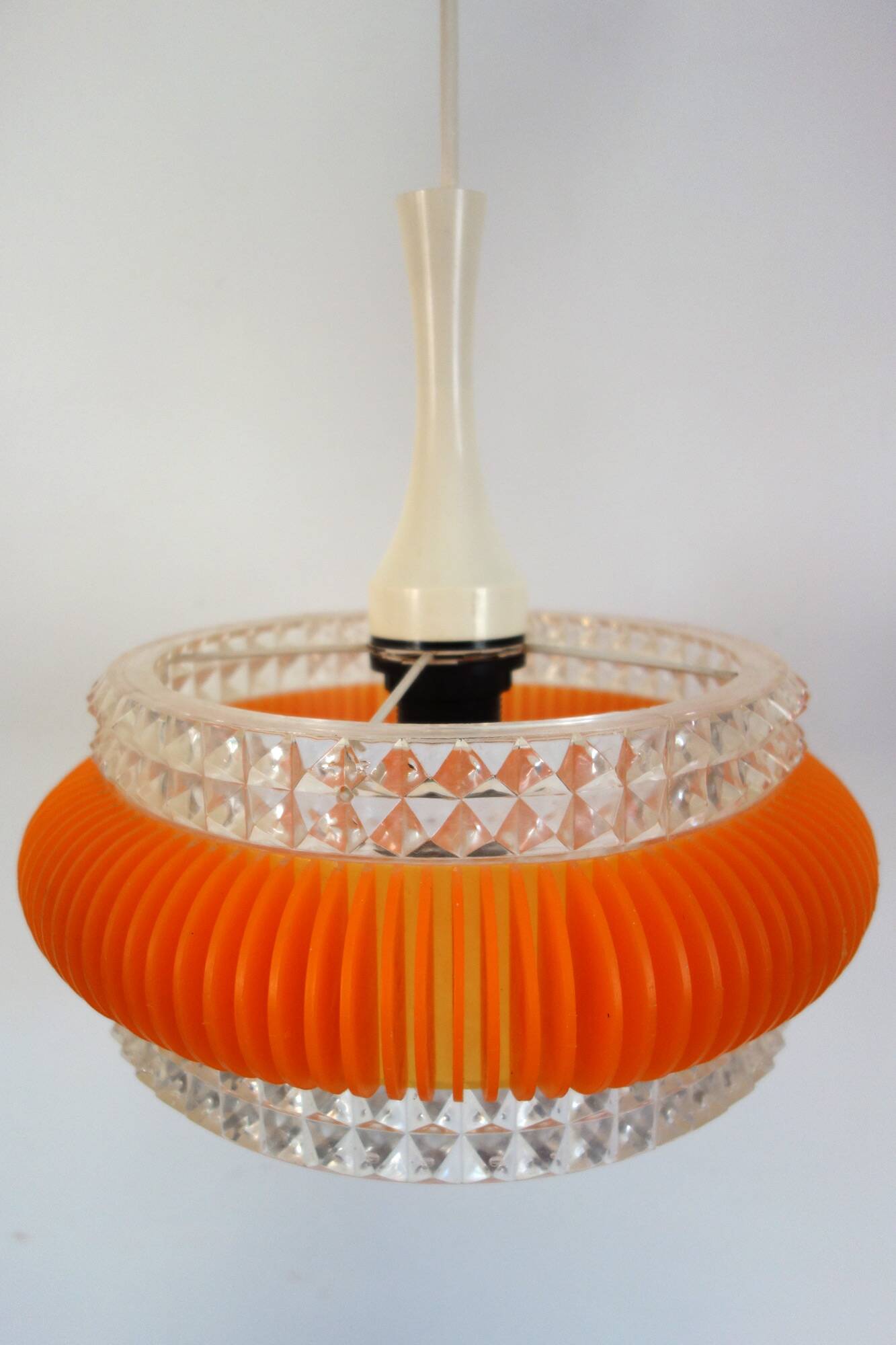 Transparent plastic space age lustre with orange band from the 70s.