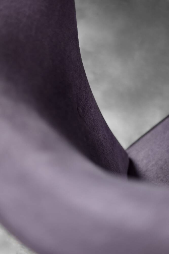 High-backed wing chair in oak and purple fabric, vintage Scandinavian style from the 1950s.