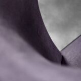 High-backed wing chair in oak and purple fabric, vintage Scandinavian style from the 1950s.