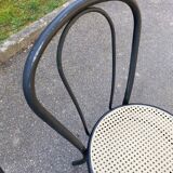 Pair of black steel and plastic cane bistro chairs