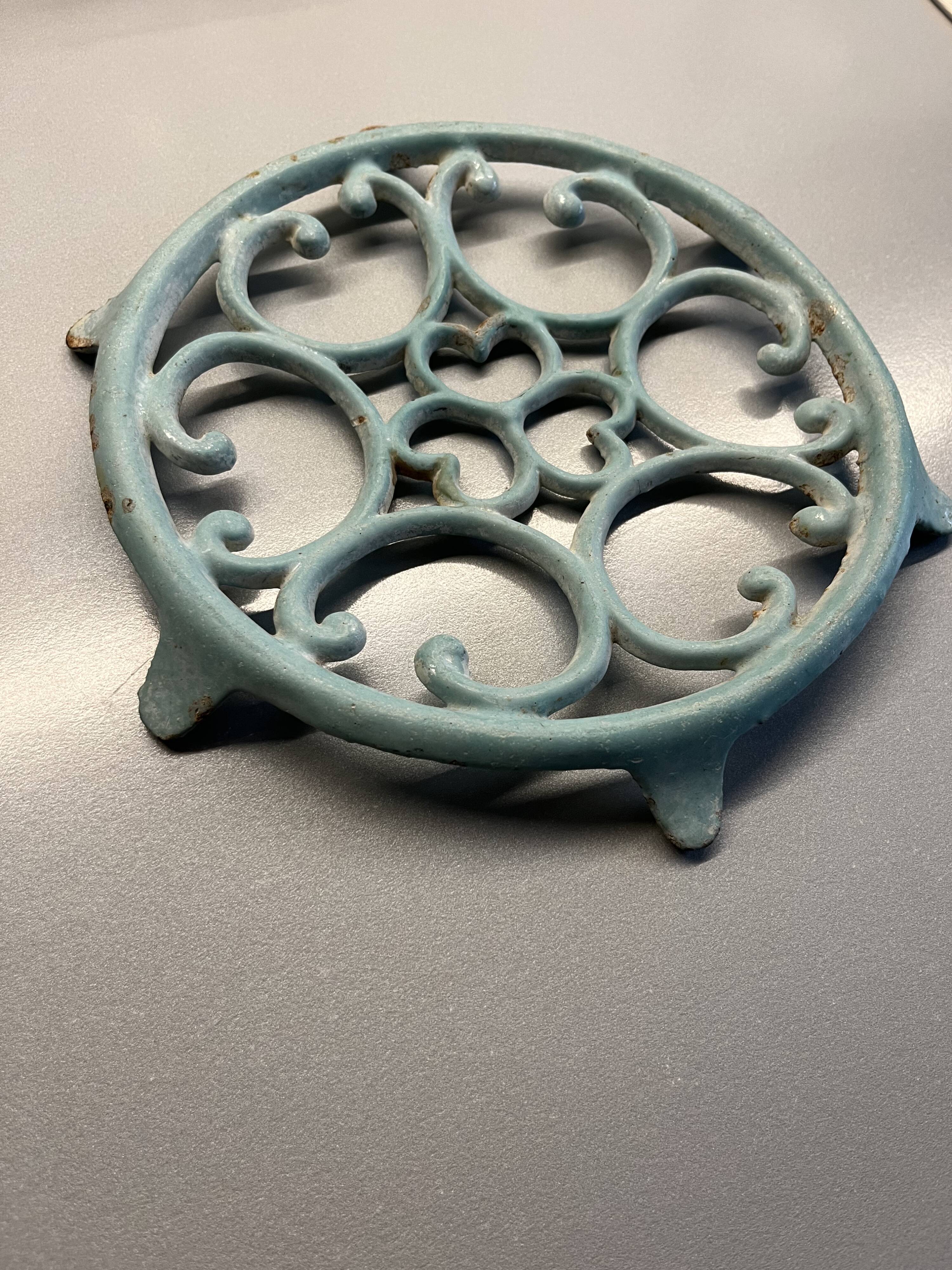 Old cast iron trivety turquoise