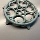 Old cast iron trivety turquoise