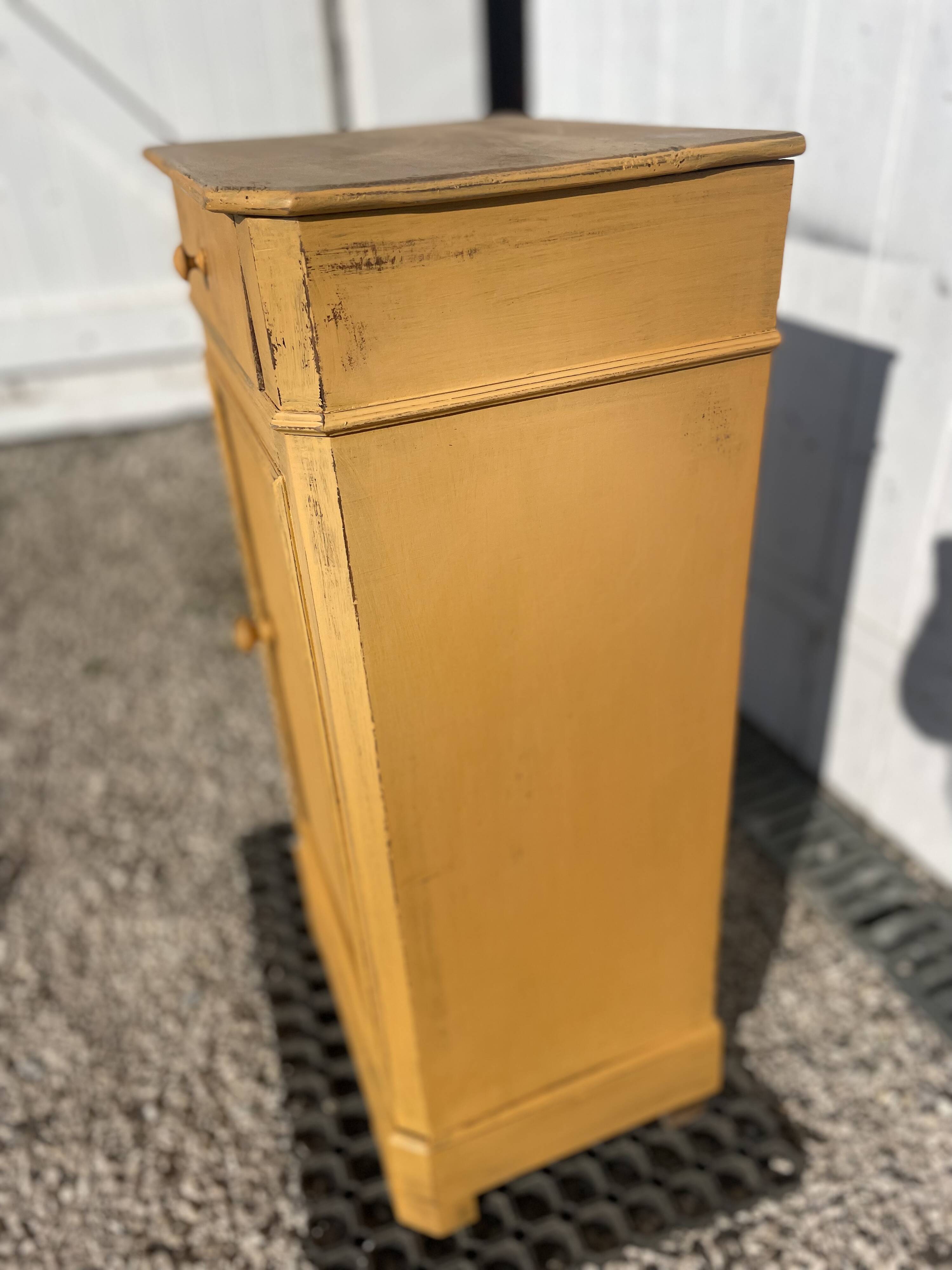 Yellow painted wooden bedside table