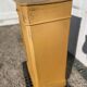 Yellow painted wooden bedside table