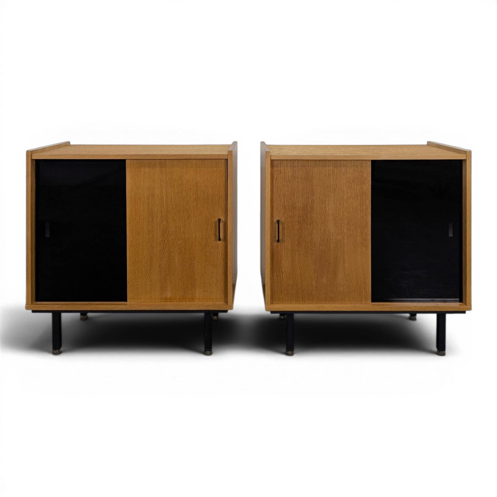 Pair of modernist sideboards with black glass doors in oak veneer.