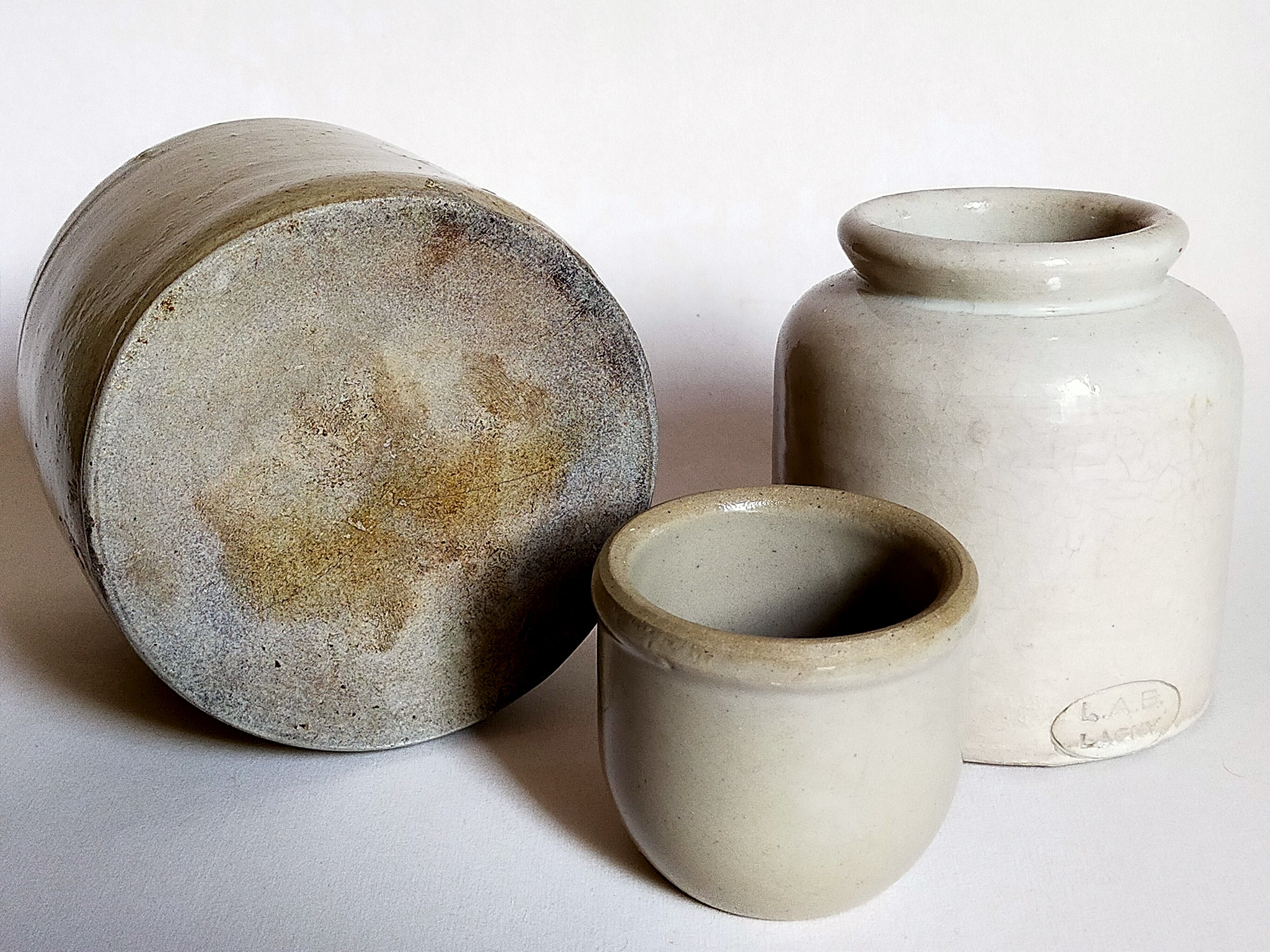 Set of three pots with old condiments in glazed earth