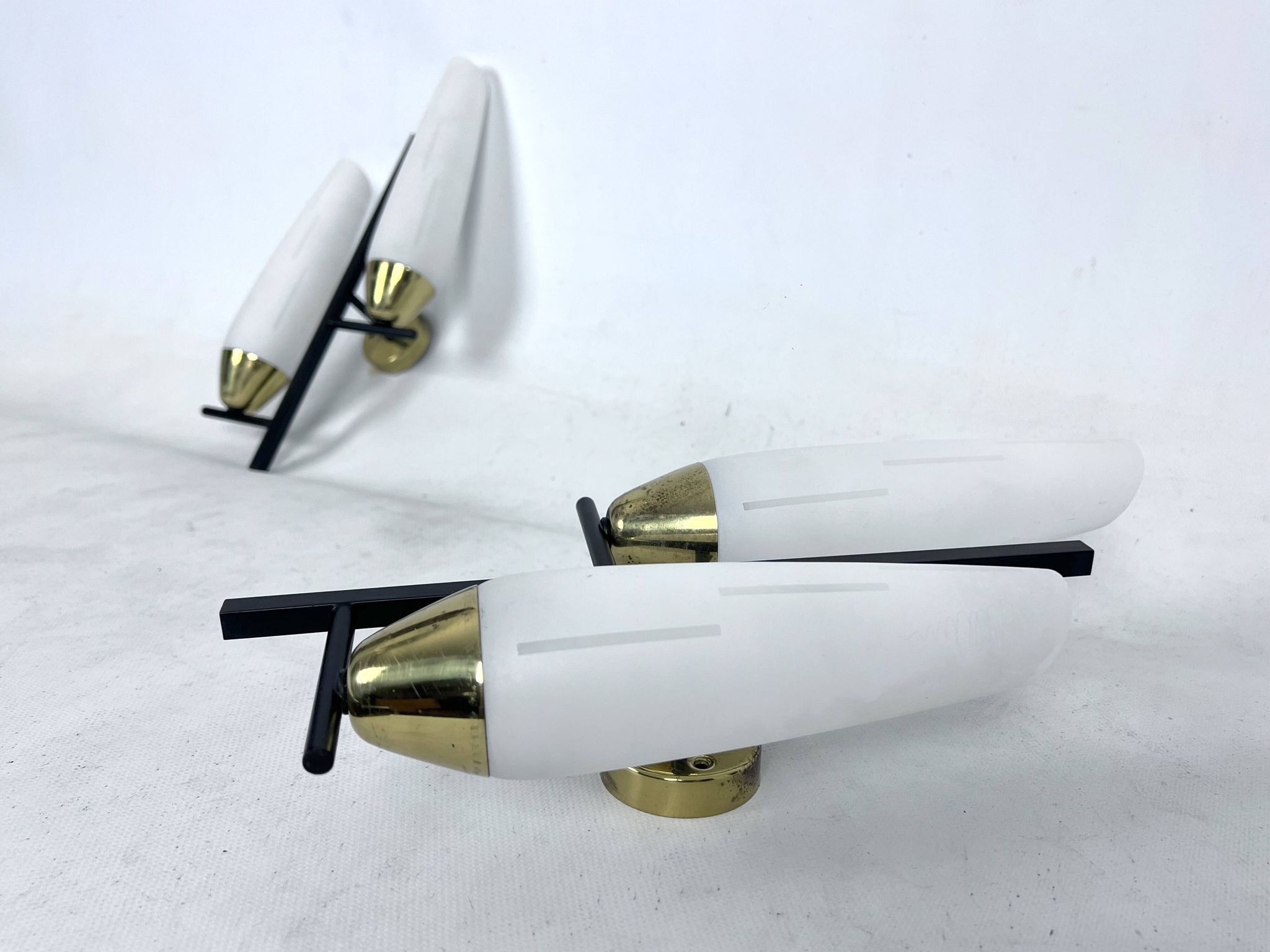 Mid-Century pair of double lights sconces in brass and opaline glass. Italy 1950s