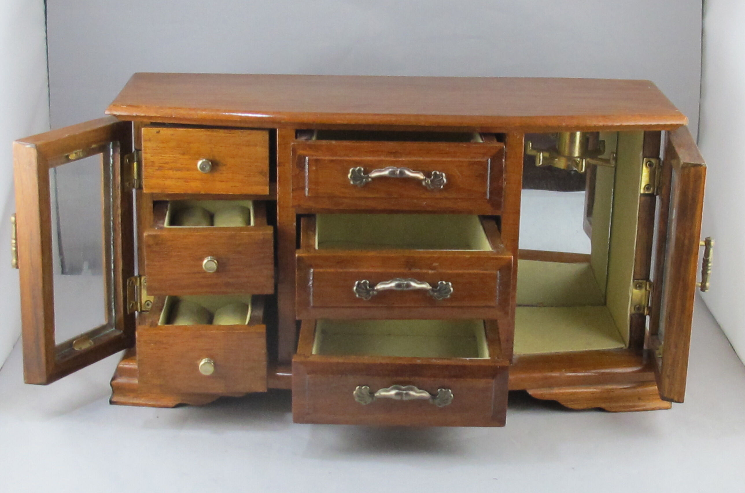 Wooden jewelry box in the shape of a chest of drawers