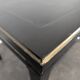 Large flat desk in Louis XVI style, black lacquered with gold highlights.