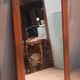 Bevelled mirror surrounded by a wooden frame.