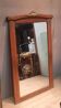 Bevelled mirror surrounded by a wooden frame.