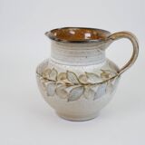 Glazed ceramic jug with plant decoration