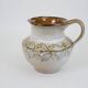 Glazed ceramic jug with plant decoration