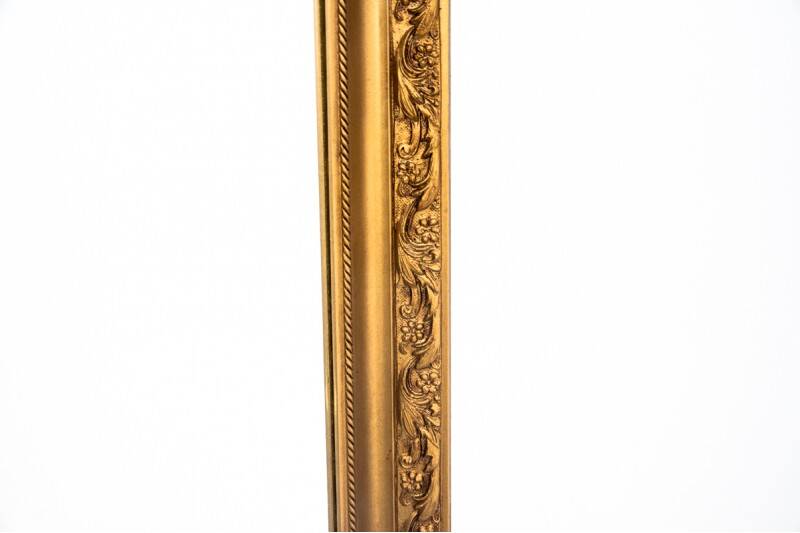 A mirror in a golden frame